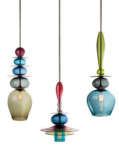 three different colored glass lights hanging from a ceiling