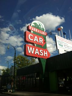 a car wash sign in front of a parking lot