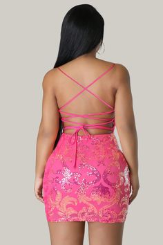 This Sequined V-neck Dress in a stunning, luxurious pink color features a sexy backless design with a zipper. The plain pattern is complemented by a cami style and spaghetti straps, creating an elegant and exclusive look. The sleeveless design and natural waistline accentuate the slim fit and pencil hemline, making it a must-have for any sophisticated wardrobe. Crafted from high-quality sequins and a slight stretch fabric, this dress is both luxurious and comfortable. 95% Polyester, 5% Elastane Glamorous Backless Dress With Lace-up Back, Bodycon V-neck Dress With Crisscross Straps, Pink Dress With Lace-up And Strappy Back, Pink V-neck Mini Dress With Sequins, Pink Mini Dress With Lace-up Back, Pink Mini Dress With Corset Back And Spaghetti Straps, Pink Fitted Dress With Strappy Back, Party Mini Dress With Sweetheart Neckline And Tie Back, Backless Dress With Sweetheart Neckline And Tie Back