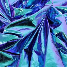 blue and green metallic fabric is shown in this image