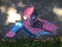 a drawing of a spider man sitting on the ground