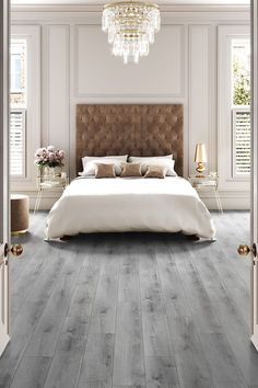 Modern bedroom, with a large bed, gold accents and grey laminate flooring. Floor Bedroom Ideas, Grey Laminate Flooring, Direct Wood Flooring, Grey Wood Floors, Oak Laminate Flooring, Luxury Vinyl Tile Flooring, Grey Laminate, Vinyl Tile Flooring, Oak Laminate