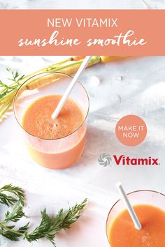 two glasses filled with orange smoothie and garnished with fresh herbs on the side