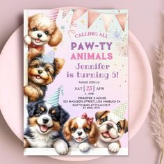 a birthday party card with puppies on it and a pink plate next to it