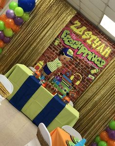 an image of a birthday party setting with balloons and streamers on the wall in the background