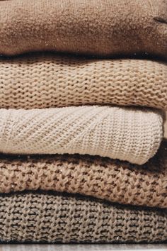 a stack of sweaters sitting on top of each other