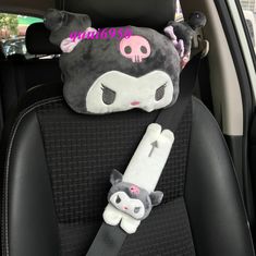 two stuffed animals sitting in the back seat of a car