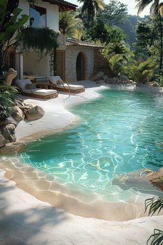 an outdoor swimming pool surrounded by palm trees and water features a stone patio with chaise lounges