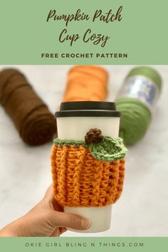 a hand holding a coffee cup sleeve with the words pumpkin patch cup cozy on it