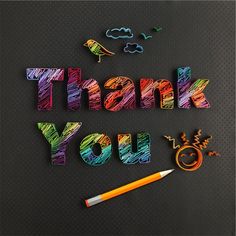 the word thank you written with crayons and colored pencils next to it