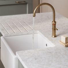 a kitchen sink with a faucet running water