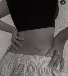 a woman's stomach with her hands on her hip and the bottom half of her pants