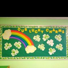 a bulletin board with shamrocks, clovers and a rainbow in the middle that says our lucky charms