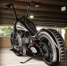 a black and silver motorcycle parked in a parking garage