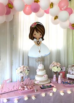 a table topped with a cake and lots of balloons