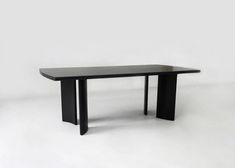 a black table sitting on top of a white floor