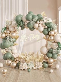 an arch made out of balloons and greenery