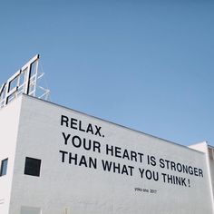 a billboard on the side of a building that says relax your heart is stronger than what you think