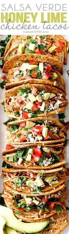 a stack of tortillas filled with chicken, lettuce and tomatoes