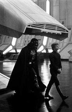 darth vader and his son walk through the hangar