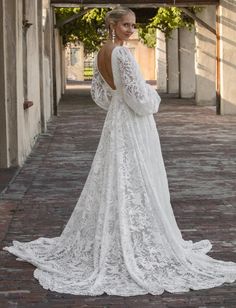 the back of a woman's wedding dress, with long sleeves and open shoulders