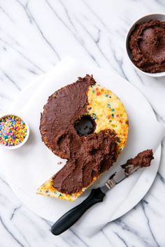 a white plate topped with a chocolate doughnut