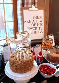 a table topped with lots of food and desserts next to a sign that says these are a few of his favorite things