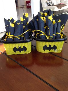 two baskets with batman decorations on them sitting on a table