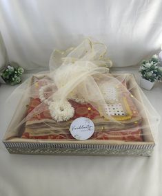 an open gift box with white flowers on it