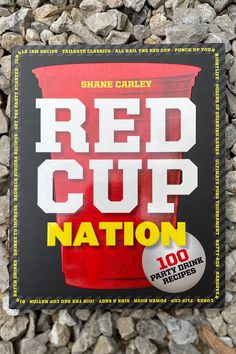 a red cup nation book sitting on top of a pile of rocks