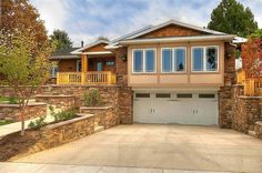 a large house with two garages in front of it