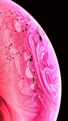 a close up view of the inside of a pink and red liquid filled bowl with black background