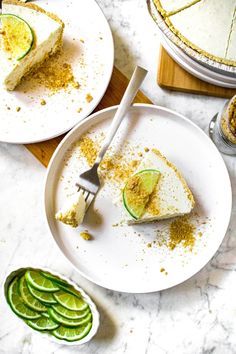 two plates with slices of pie on them next to cucumber slices and a fork