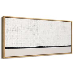 a white and black painting hanging on a wall next to a wooden framed piece with dots