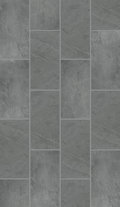 a gray tile floor with different shades of grey and white tiles on the bottom half