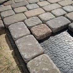 the sidewalk is made out of stone blocks and has been placed on top of each other