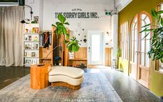 a living room filled with furniture and plants