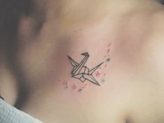 an origami bird tattoo on the chest