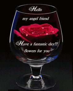 a wine glass with an image of a rose on the bottom and words above it