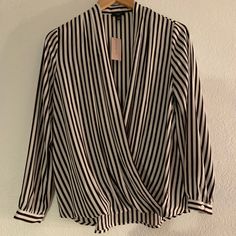 Perfect For Work Or Going Out! This Dark Navy Stripped Blouse With Blush Accents Is Sophisticated And Casual All At Once. Clip The Hidden Button Near The Chest For Extra Coverage Or Leave Open For A Sultry Look. Elegant Striped Blouse, Chic Striped Tops For Night Out, Elegant Striped Fall Blouse, Elegant Striped Blouse For Fall, Chic Striped Blouse For Spring, Elegant Striped Blouse For Summer, Chic Striped Formal Tops, Chic Formal Striped Tops, Chic Striped V-neck Blouse