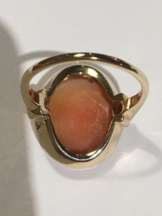 "This is a beautiful condition vintage 14kt yellow gold genuine hand carved shell cameo. Slightly worn but profile and features are very well defined in this classic face. Beautiful beaded bezel holds this cameo in place and the setting and fine detail on shank of ring are stunning. Cameo measures approximately 1/2\" wide and 5/8th \" long. Size 6. Shank is sturdy and this ring will last for generations to come. A true timeless classic. Inside is hallmarked(unreadable) and 14kt is stamped in it. Cameo 14k Gold Rings For Collectors, Collectible 14k Gold Cameo Rings, Elegant Oval Cameo Engraved Ring, 14k Gold Cameo Rings For Collectors, Classic Gold Cameo Signet Ring, Classic Oval Cameo Rings, Gold Oval Cameo Signet Ring, Oval Cameo Yellow Gold Ring, Yellow Gold Cameo Signet Ring