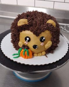 there is a cake made to look like a hedgehog with a pumpkin in its mouth