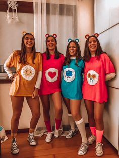 four girls dressed in costumes posing for the camera