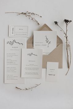 the wedding stationery is laid out on top of each other