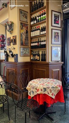 an image of a restaurant setting with wine bottles on the wall and table cloths