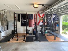 a home gym with american flags hanging on the wall and other equipment in the room