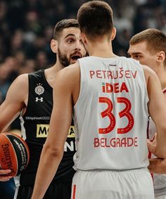 two basketball players standing next to each other