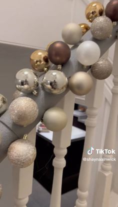 an image of christmas ornaments on the banister