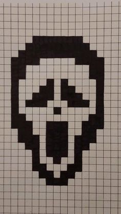 a white tiled wall with a black and white skull drawn on it's face