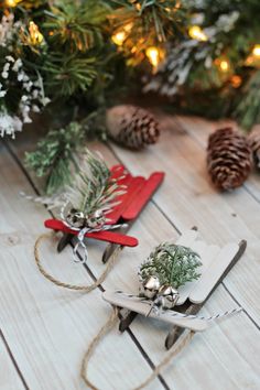 two small wooden sleds with christmas decorations on them